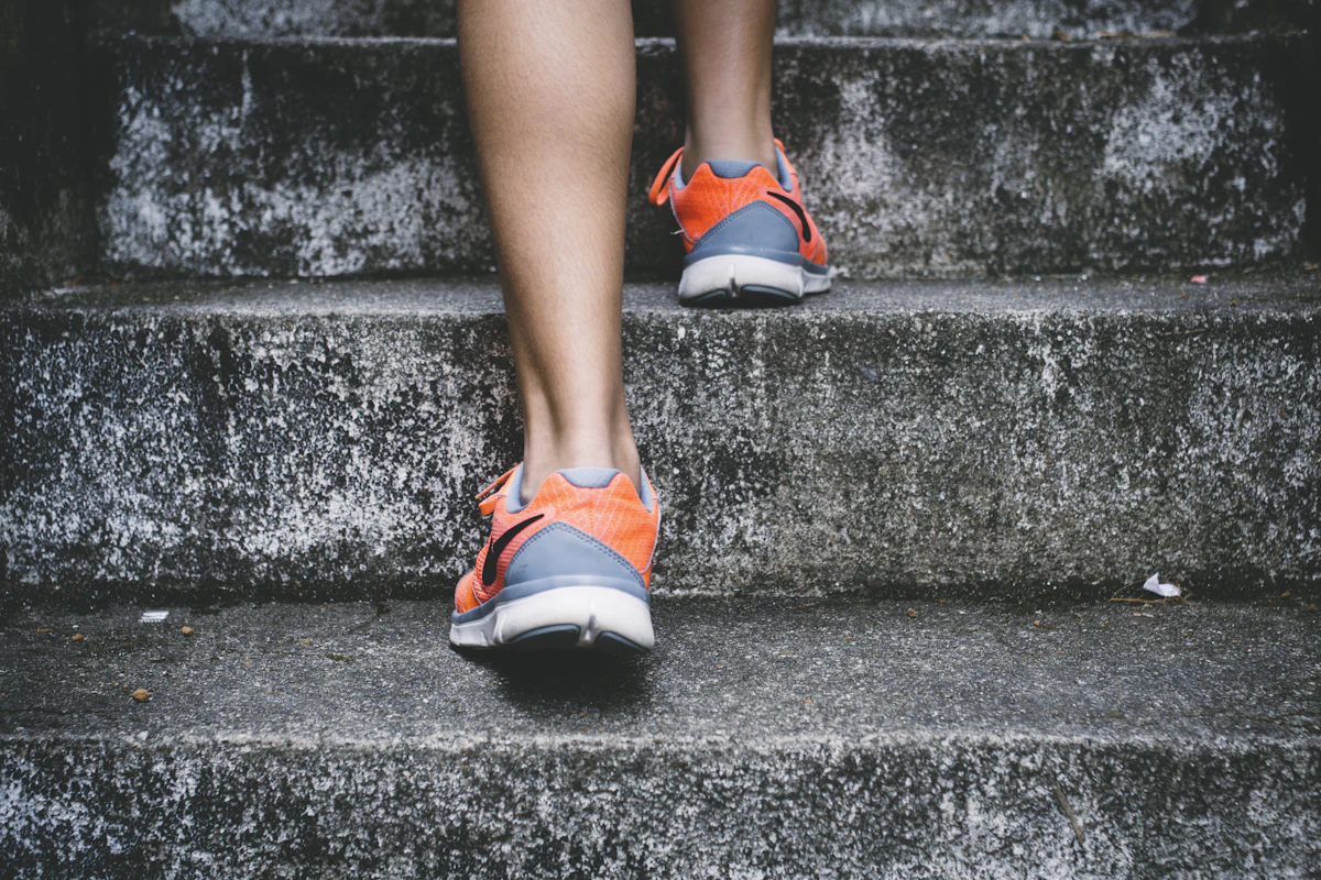 Runner exercising outdoors on a path beside a grassy field